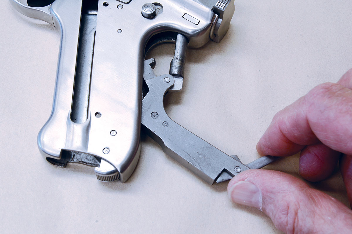 Pull out and down to remove bolt stop/mainspring assembly.